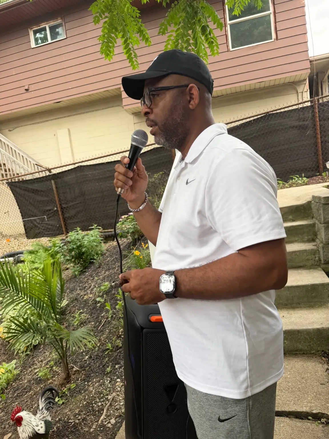 A community leader speaking outdoors at a neighborhood event