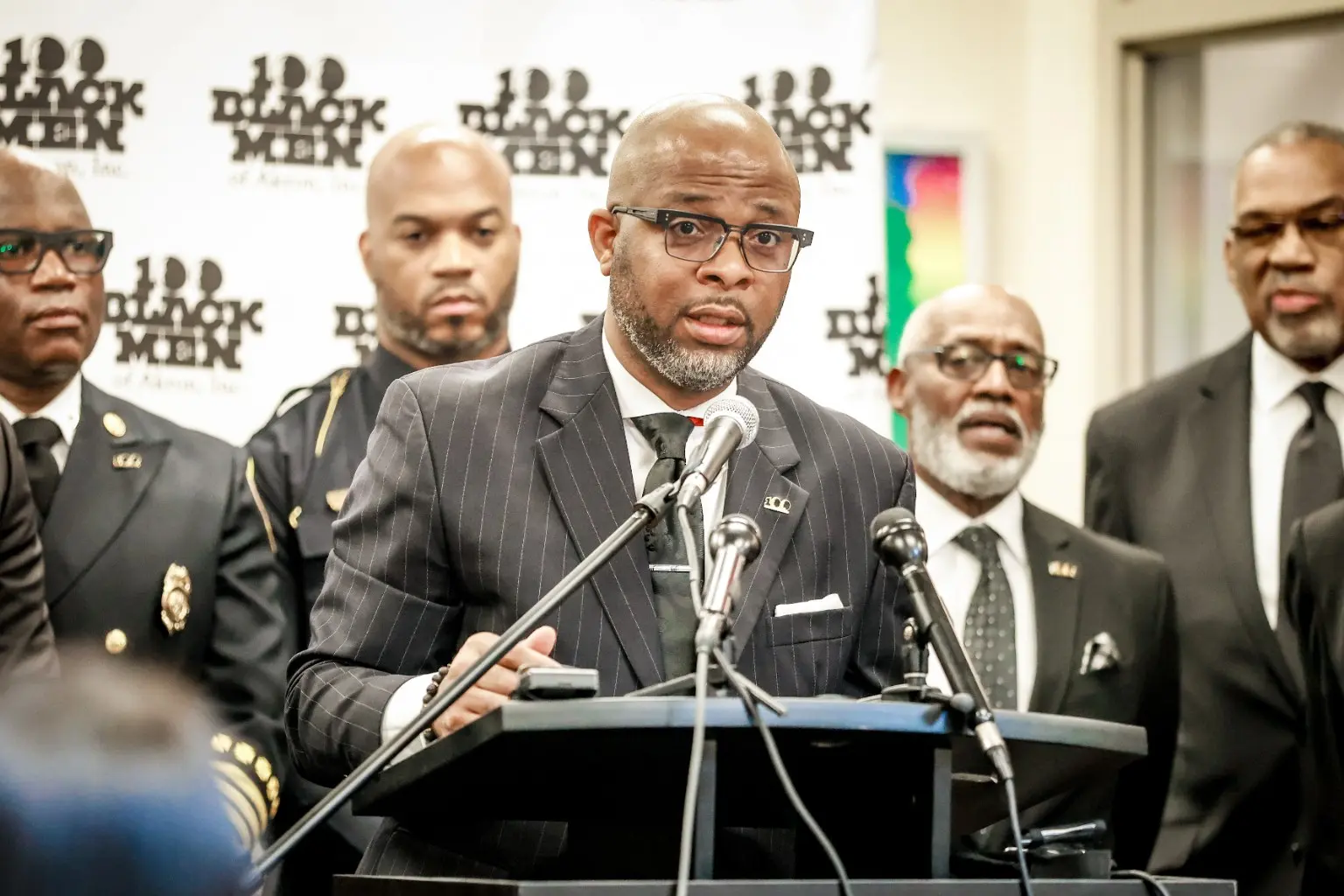 A 100 Black Men of Akron leader speaking at a press conference