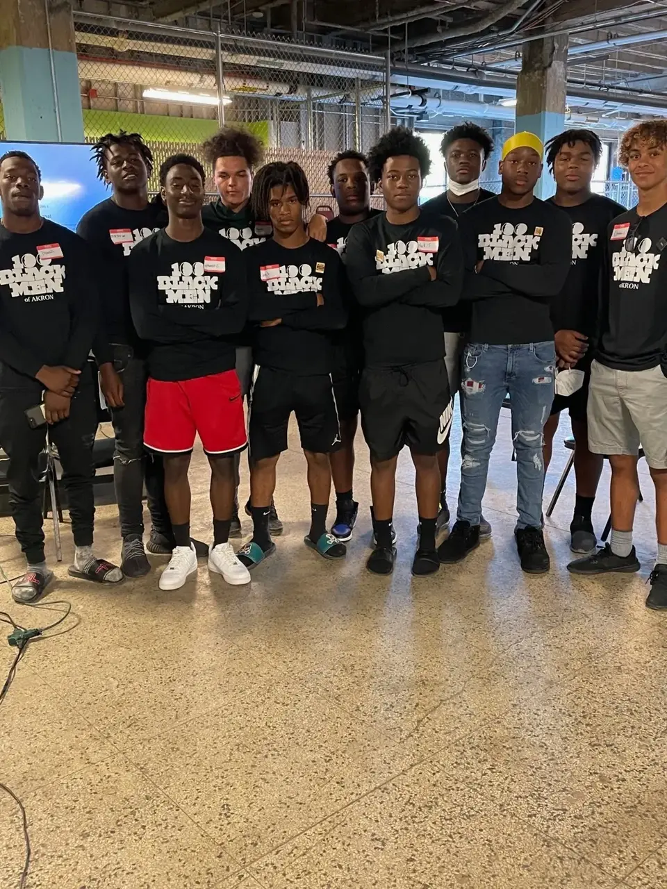 Older Leadership Academy participants gathered together in 100 Black Men of Akron shirts
